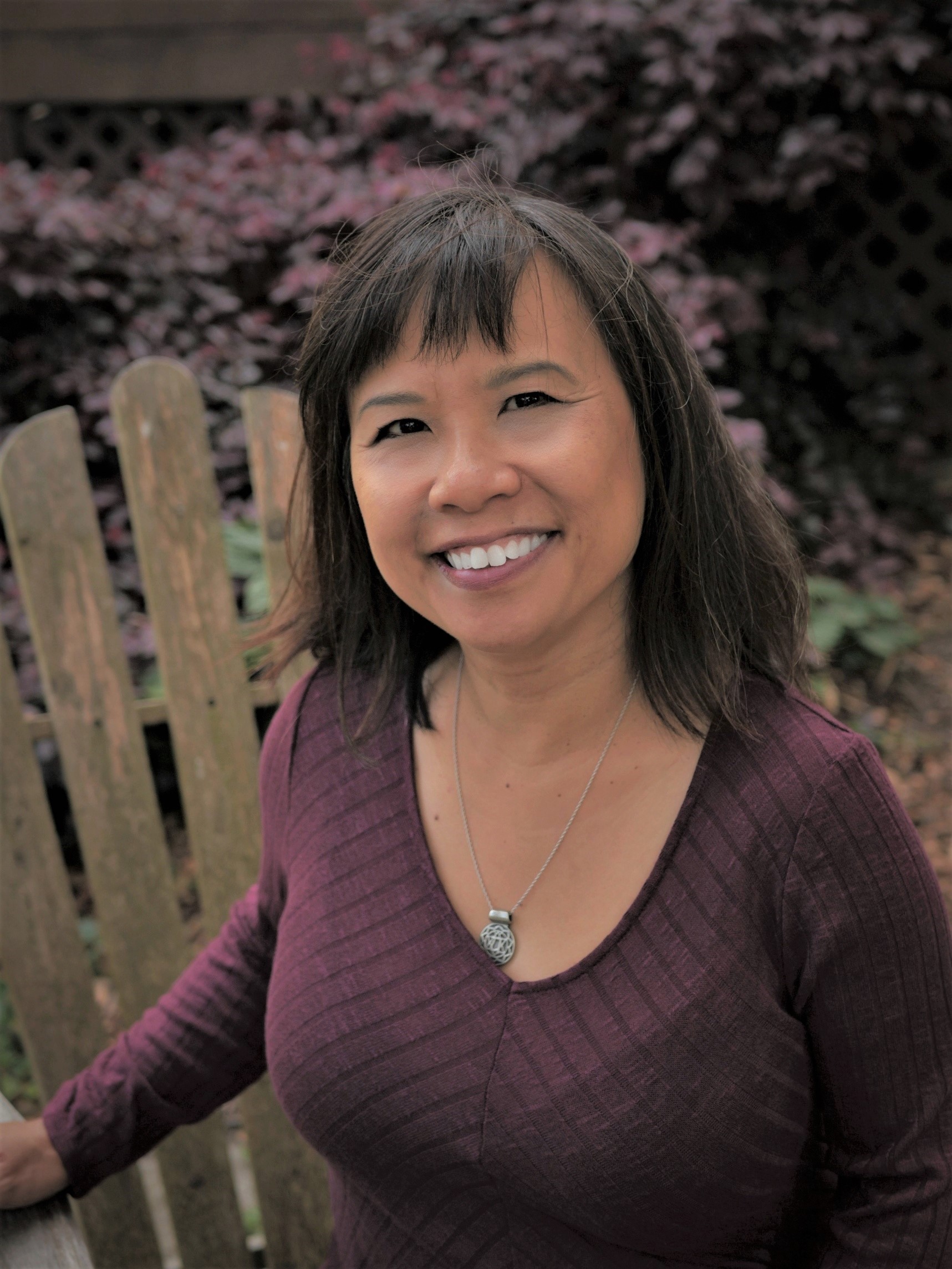 lynn cheng, chinese medicine herbalist and acupuncturist, sitting on a chair outdoors